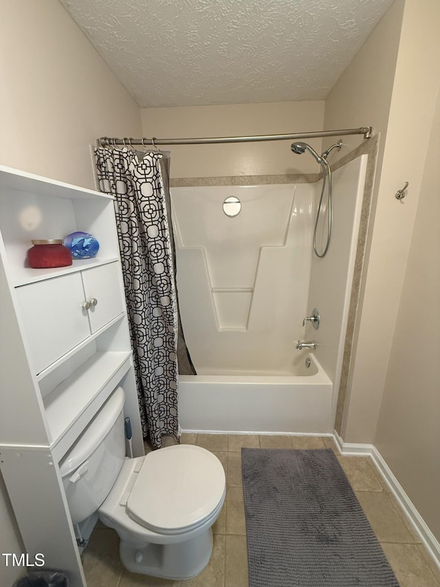 bathroom with toilet, shower / tub combo, a textured ceiling, baseboards, and tile patterned floors