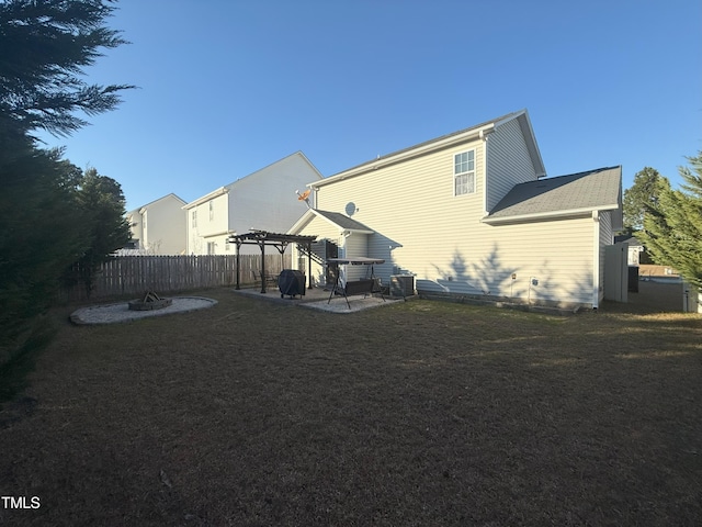 rear view of house featuring a patio, a lawn, central AC, fence, and a pergola