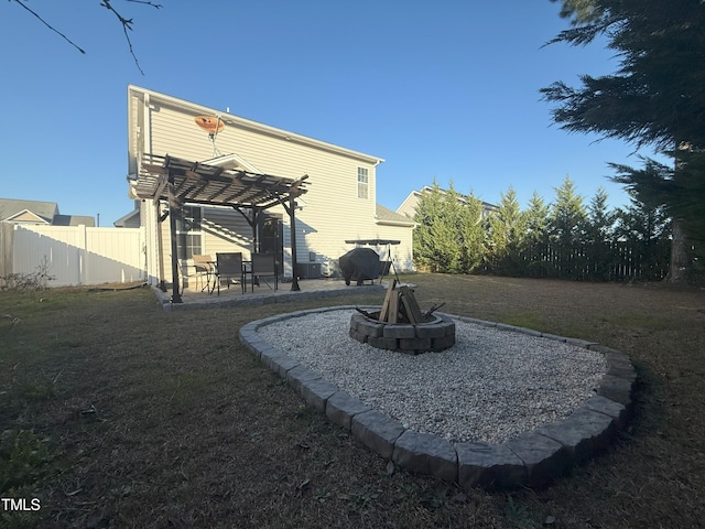 back of house featuring an outdoor fire pit, fence, a yard, a patio area, and a pergola