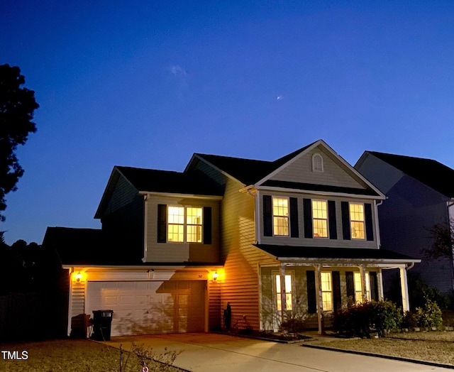 traditional home with a garage and concrete driveway