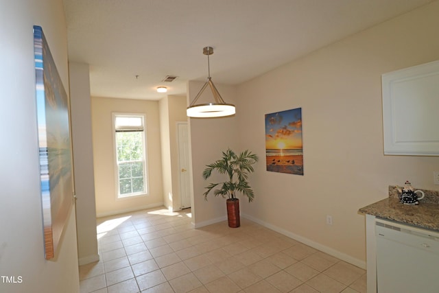 unfurnished dining area featuring visible vents, baseboards, and light tile patterned floors