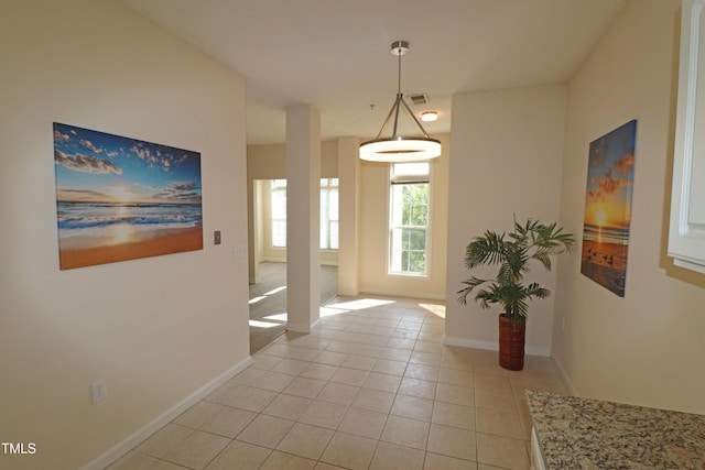 interior space featuring visible vents, baseboards, and light tile patterned floors