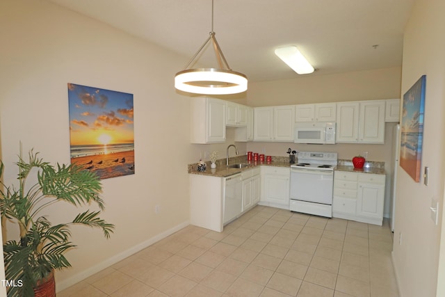 kitchen featuring white appliances, baseboards, white cabinets, decorative light fixtures, and a sink