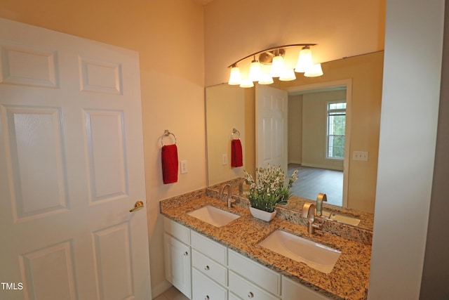 bathroom with a sink and double vanity