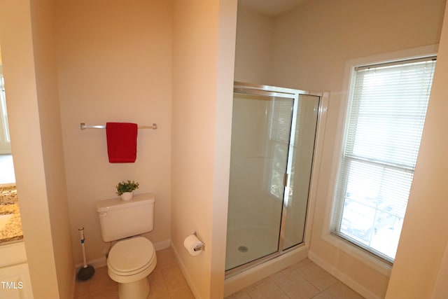 bathroom featuring baseboards, toilet, tile patterned floors, vanity, and a shower stall