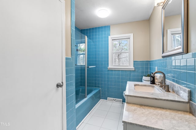 bathroom with vanity, visible vents, tile walls, shower / bathing tub combination, and tile patterned floors