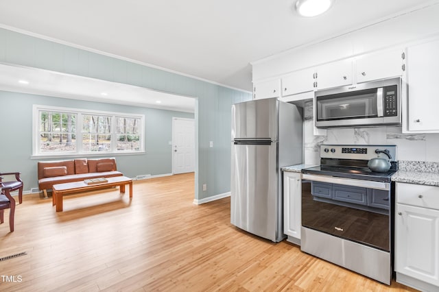 kitchen featuring light wood-style flooring, stainless steel appliances, visible vents, white cabinets, and crown molding