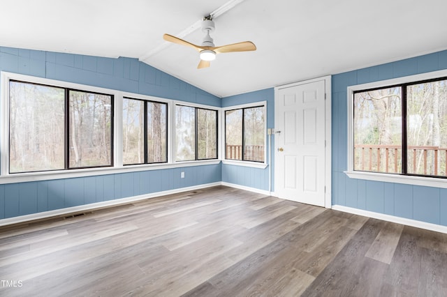 interior space with vaulted ceiling with beams, ceiling fan, visible vents, and a healthy amount of sunlight