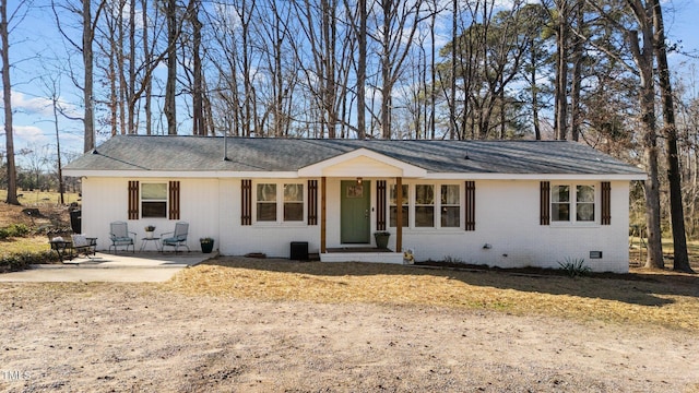 single story home featuring crawl space, a patio area, and brick siding