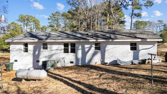 view of property exterior featuring crawl space, central AC unit, and brick siding