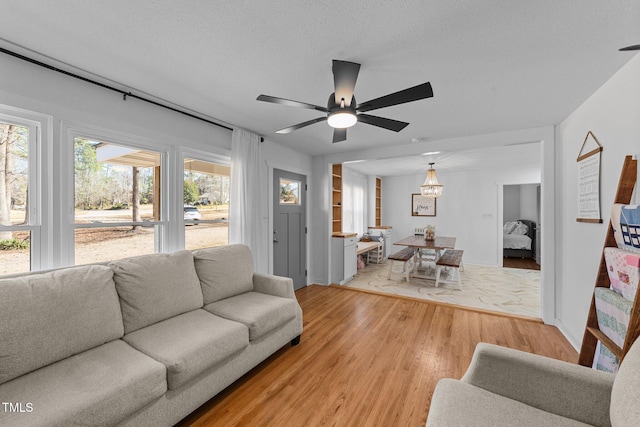 living area with a textured ceiling and light wood-style floors