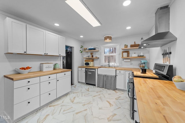 kitchen featuring butcher block countertops, marble finish floor, range hood, stainless steel appliances, and open shelves