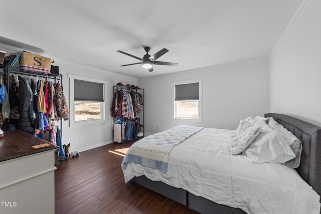 bedroom with multiple windows, wood finished floors, and crown molding