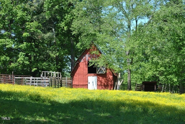 view of barn with fence