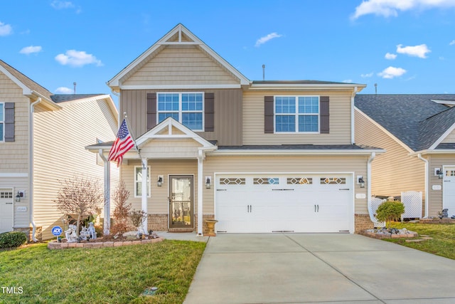 craftsman-style house with board and batten siding, a front lawn, driveway, and an attached garage