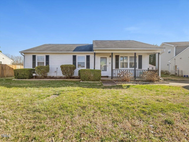 ranch-style home featuring a porch, a front yard, and fence