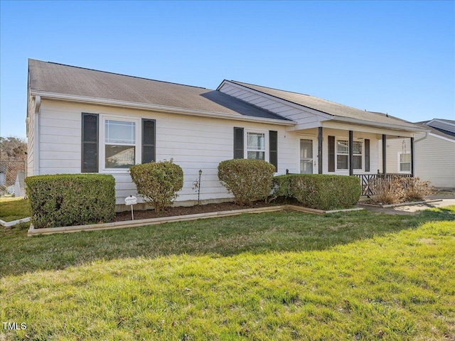 ranch-style house featuring a porch and a front yard