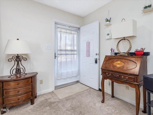 doorway to outside with baseboards and light carpet