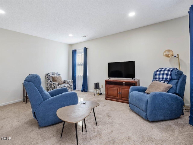 living area with visible vents, baseboards, and carpet flooring