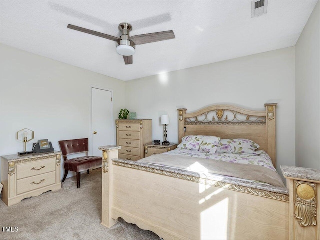 bedroom featuring light carpet, visible vents, and a ceiling fan