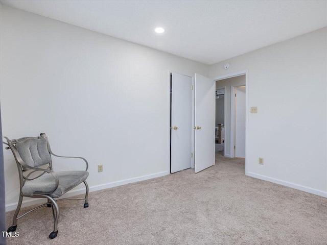 living area with recessed lighting, baseboards, and carpet floors