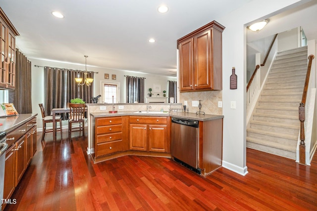 kitchen featuring brown cabinetry, decorative backsplash, dishwasher, dark wood-type flooring, and a peninsula