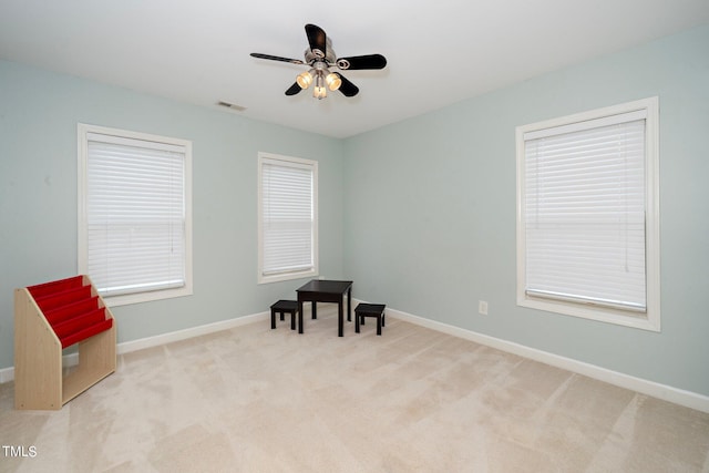 living area featuring baseboards, visible vents, and carpet flooring