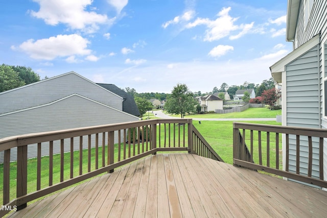 deck featuring a residential view and a yard