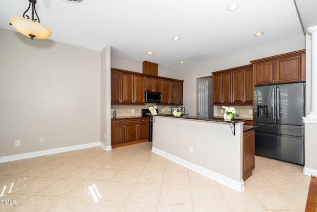 kitchen with stainless steel fridge, decorative backsplash, and light tile patterned flooring