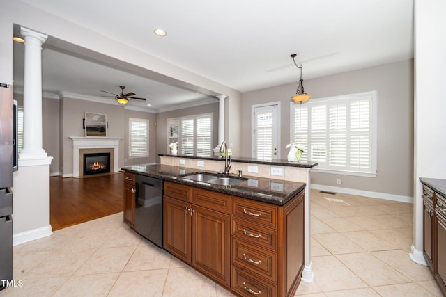 kitchen featuring light tile patterned floors, brown cabinetry, dishwasher, ornate columns, and a sink