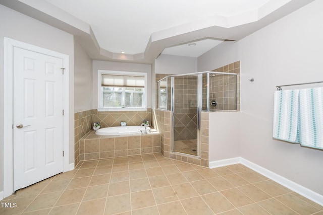 full bathroom featuring a garden tub, tile patterned flooring, baseboards, and a stall shower