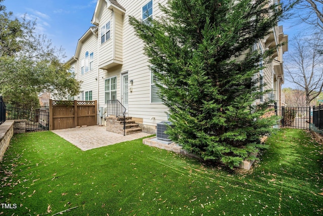 rear view of property with a yard, a fenced backyard, a patio area, and cooling unit