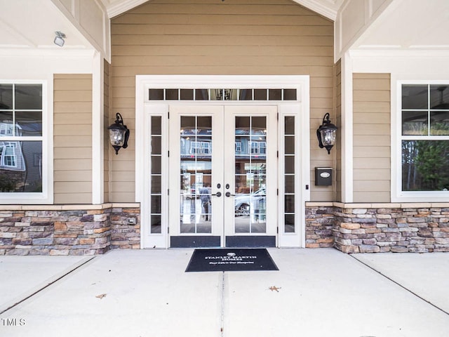 entrance to property with stone siding and french doors