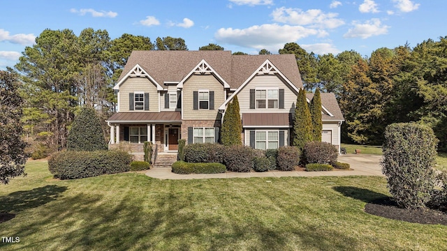 craftsman-style home with a porch, a front yard, concrete driveway, and an attached garage