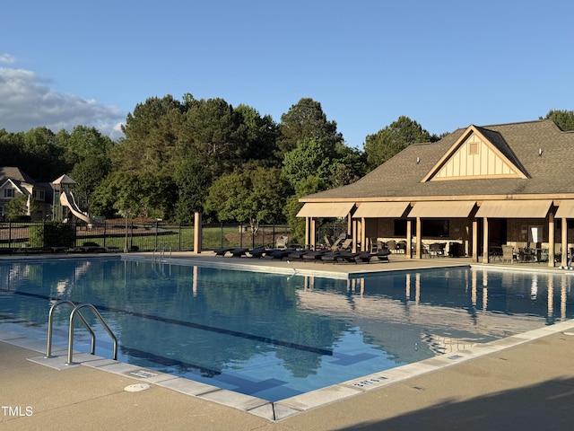 community pool featuring fence and a patio