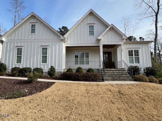 modern inspired farmhouse with covered porch and board and batten siding