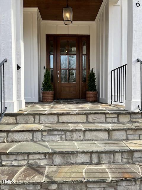 view of exterior entry with a porch