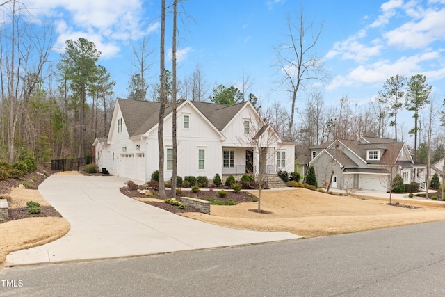 view of front of home featuring a garage, a residential view, board and batten siding, and concrete driveway