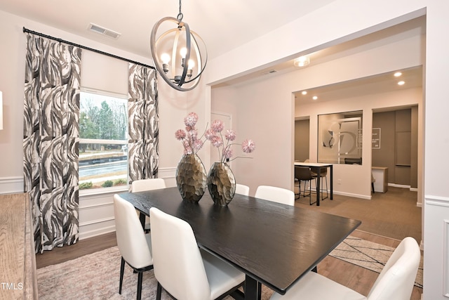 dining space with visible vents, a chandelier, wood finished floors, and recessed lighting