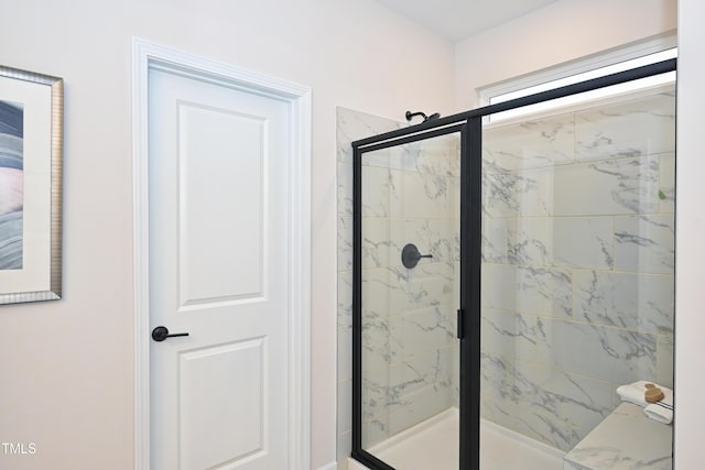 bathroom with a marble finish shower