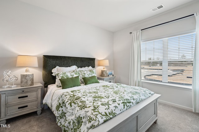 bedroom featuring light carpet, baseboards, and visible vents