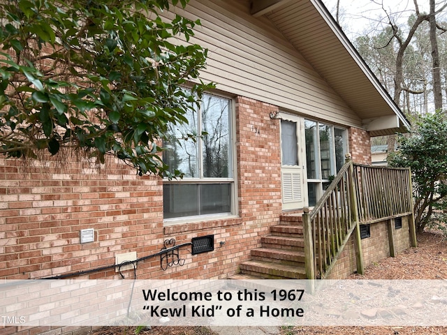 property entrance with brick siding