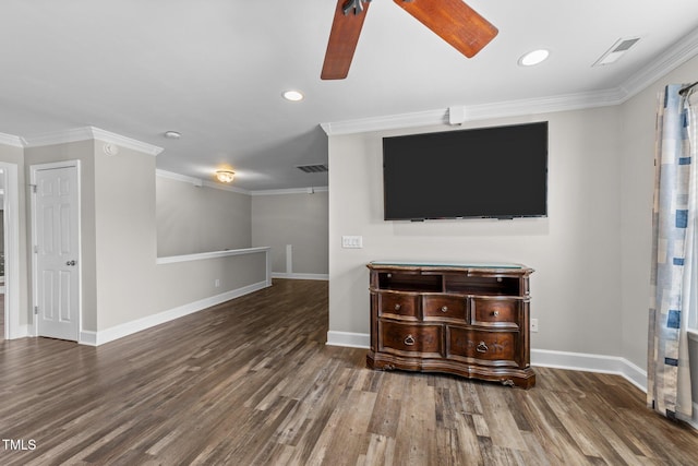 unfurnished living room featuring crown molding, baseboards, and wood finished floors