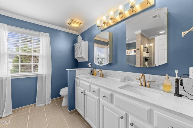 full bath featuring ornamental molding, visible vents, a tile shower, and a sink