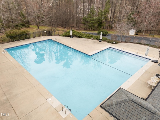 pool featuring a patio area and fence