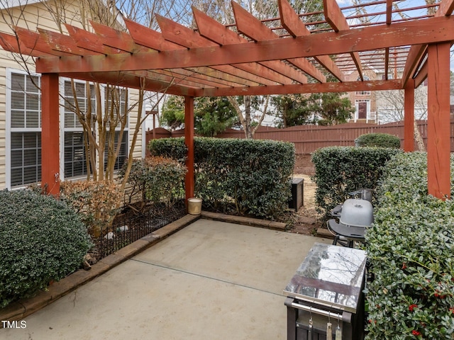 view of patio with a pergola and fence