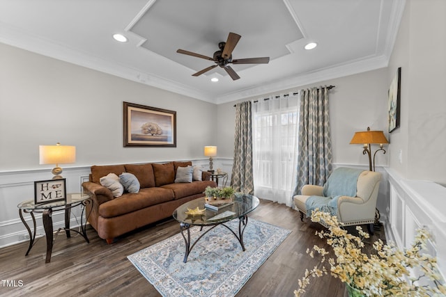 living area featuring a wainscoted wall, a ceiling fan, wood finished floors, recessed lighting, and crown molding