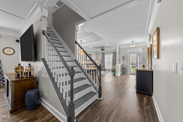 stairs featuring ceiling fan, baseboards, wood finished floors, and ornamental molding