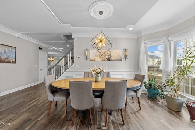 dining room featuring a notable chandelier, crown molding, and wood finished floors