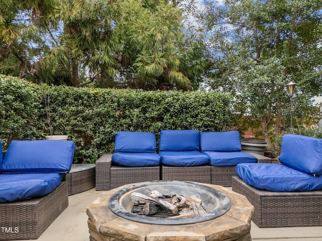 view of patio featuring an outdoor living space with a fire pit